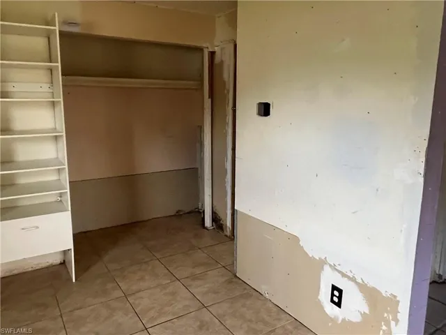 Unfurnished bedroom featuring light tile patterned flooring
