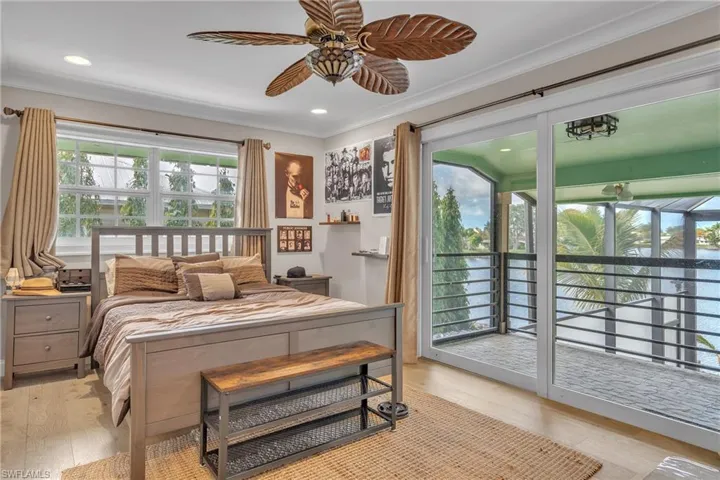 Bedroom with light wood-type flooring, crown molding, access to exterior, a ceiling fan, and recessed lighting