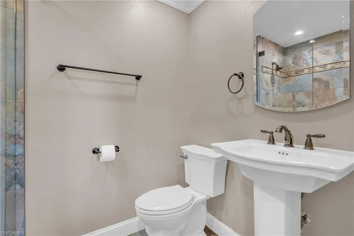 Bathroom featuring toilet and tiled shower