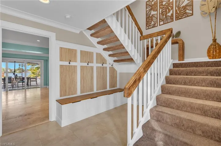 Stairs with crown molding and recessed lighting