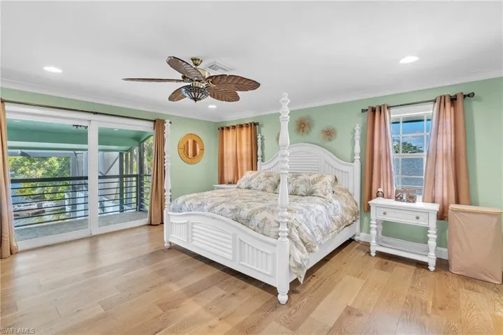 Bedroom with access to exterior, light wood finished floors, ceiling fan, recessed lighting, and crown molding