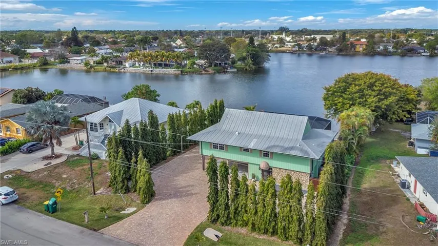 Aerial perspective of suburban area featuring a large body of water