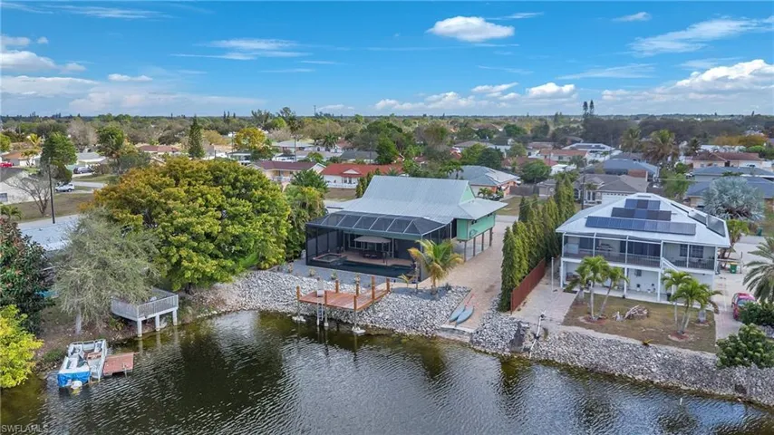 Aerial view of residential area featuring a nearby body of water