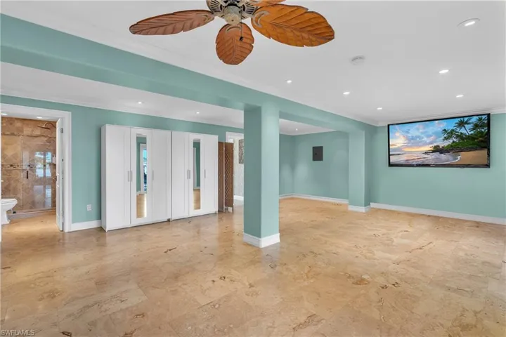 Downstairs Unfurnished room with recessed lighting, ceiling fan, and ornamental molding