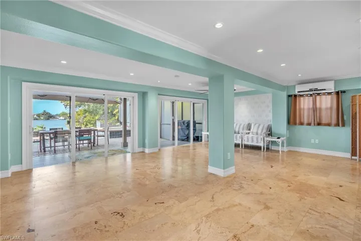 Living area featuring recessed lighting, crown molding, and a water view