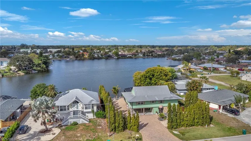 Aerial perspective of suburban area featuring a nearby body of water