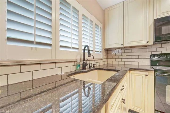 Subway tile backsplash and synthetic granite double sinks
