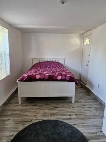 Bedroom with baseboards and light wood finished floors