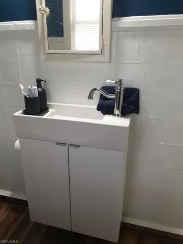 Bathroom with wood finished floors and vanity