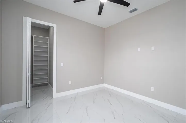 Unfurnished bedroom with a closet and ceiling fan