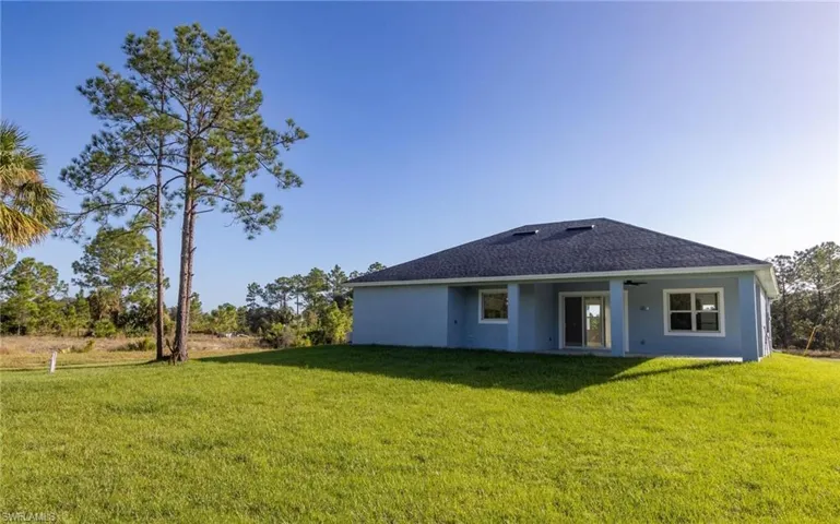 Rear view of property featuring a lawn