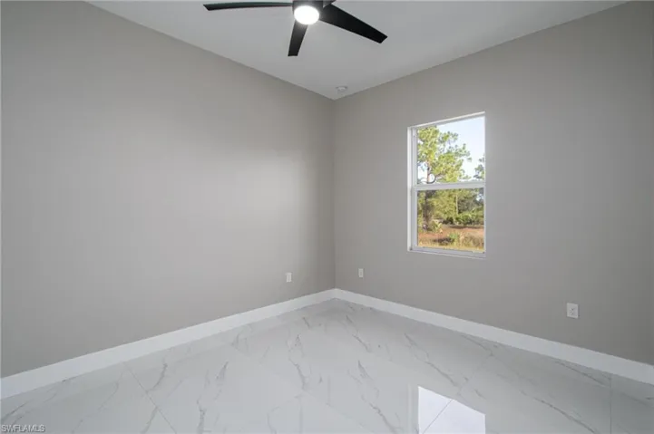 Spare room with ceiling fan