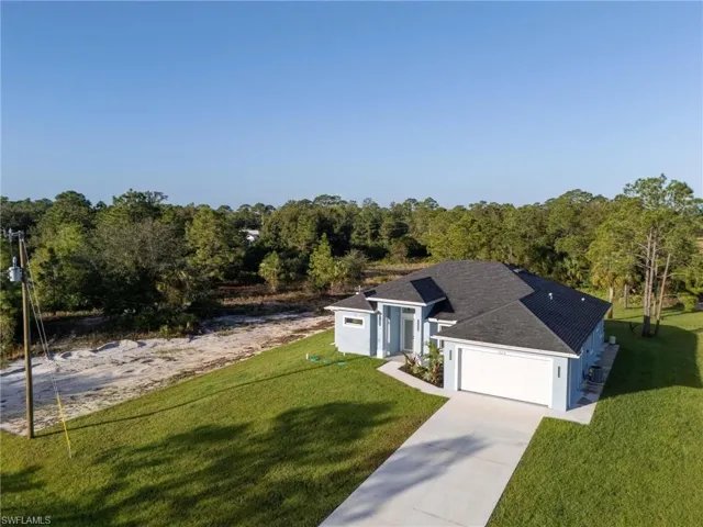 View of front facade with a front lawn and a garage