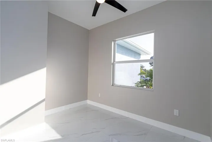 Spare room with ceiling fan