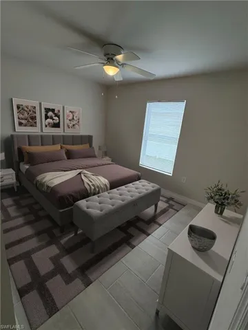 Bedroom featuring ceiling fan and light hardwood / wood-style floors  ( Virtual Staged )