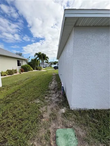 View of home's exterior with a yard