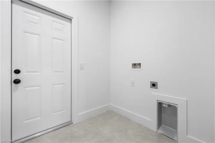 Clothes washing area with hookup for a washing machine and hookup for an electric dryer