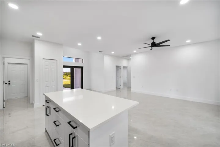 Kitchen featuring ceiling fan, french doors, and a kitchen island