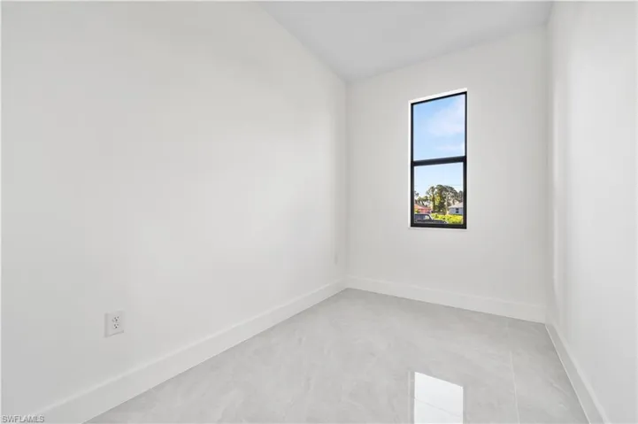 Empty room with light tile floors