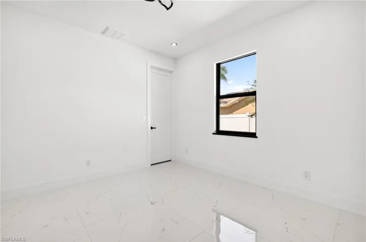 Spare room featuring light marble finish floors and recessed lighting