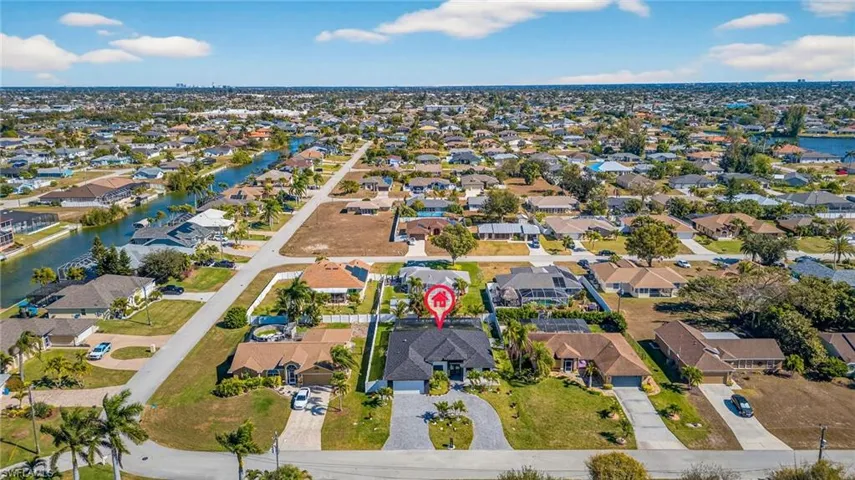Aerial view of property's location with nearby suburban area and a large body of water