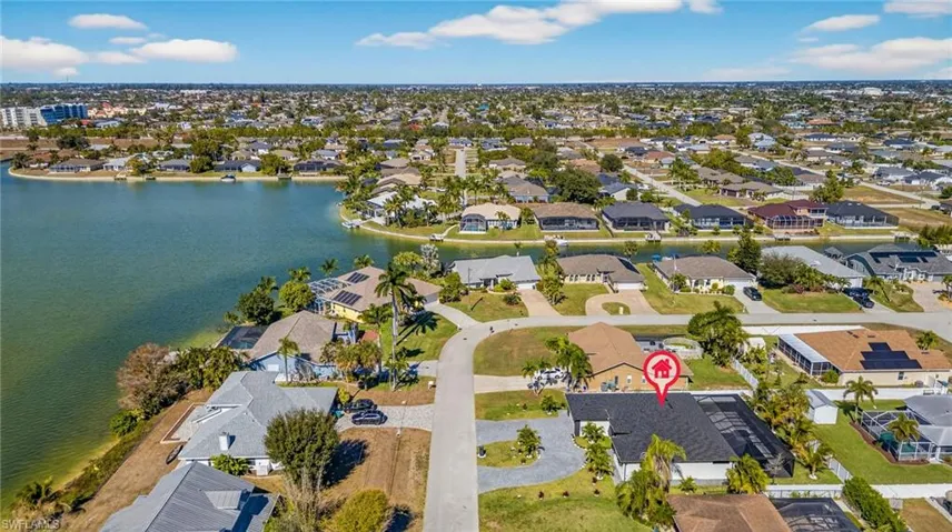 View of property location featuring a nearby body of water and nearby suburban area