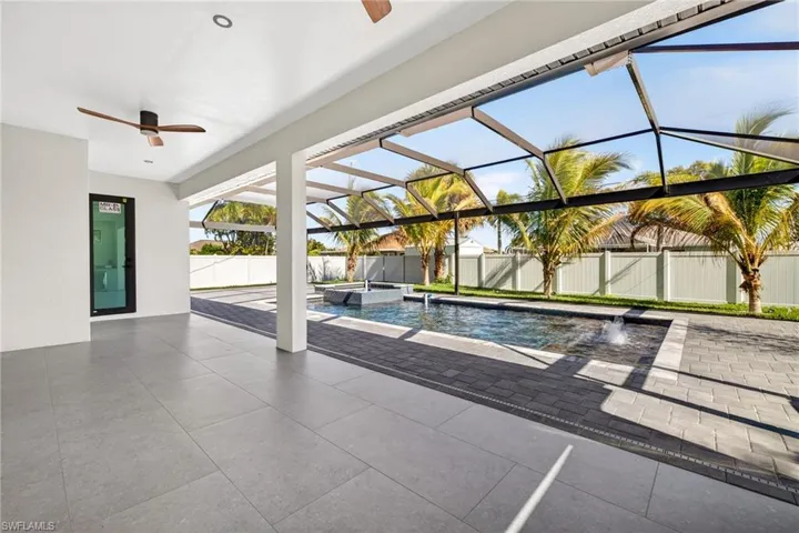 Integrated pool / spa featuring a lanai, a patio, a sunroom, and a fenced backyard