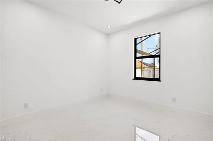 Unfurnished room featuring light marble finish flooring and recessed lighting