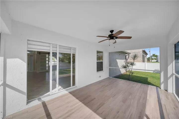 Deck featuring a sunroom and ceiling fan