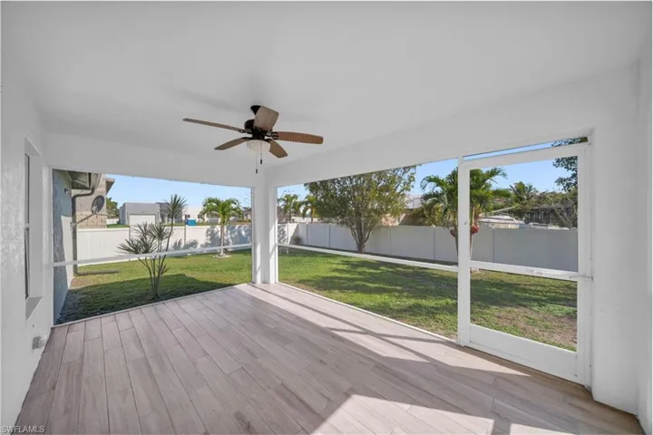Unfurnished sunroom with a ceiling fan