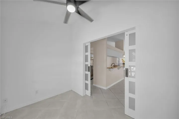 Unfurnished room featuring ceiling fan and light tile patterned floors
