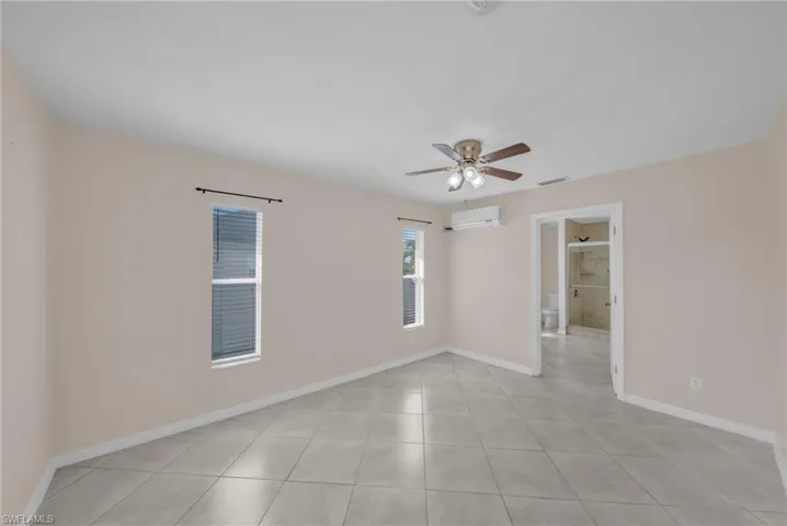Spare room featuring ceiling fan and light tile patterned floors