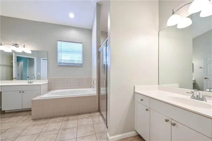 Primary bath with separate shower and soaking tub.