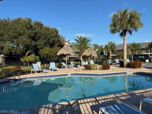Community pool with a patio