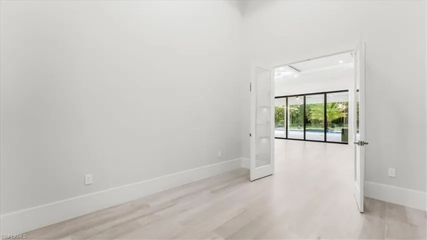 Spare room featuring light wood-type flooring and baseboards