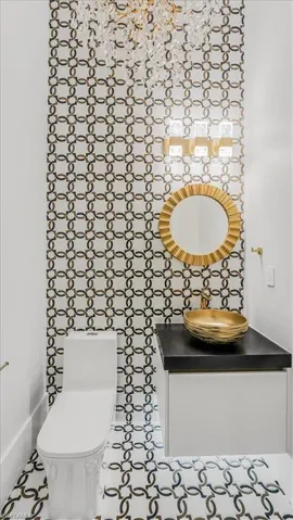 Half bath featuring vanity and tile patterned flooring