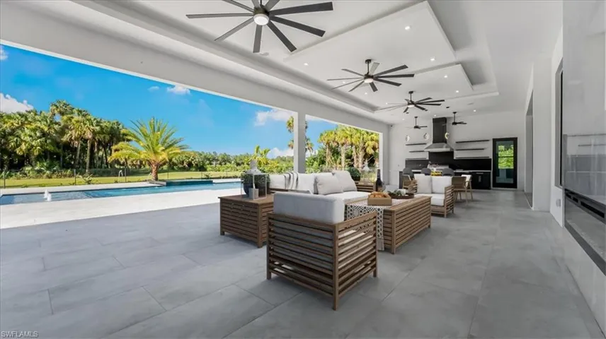 View of patio featuring outdoor lounge area, an outdoor pool, and a ceiling fan