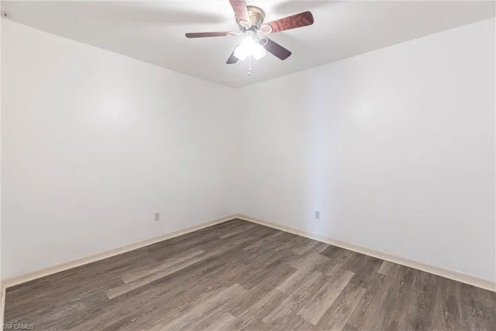 Spare room featuring wood finished floors and ceiling fan