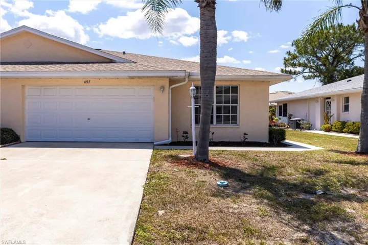 Single story home featuring a shingled roof, stucco siding, driveway, and a garage