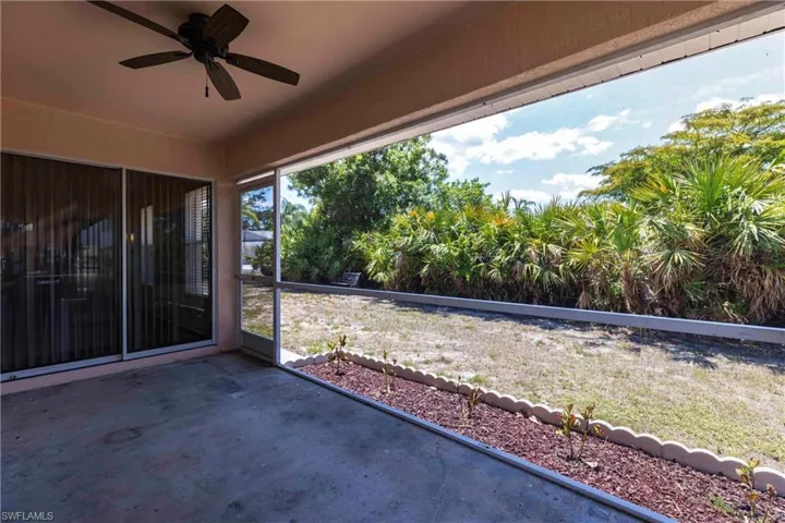 View of patio / terrace with a ceiling fan and a sunroom