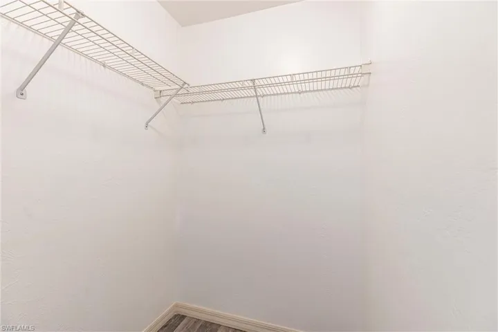 Walk in closet featuring wood finished floors