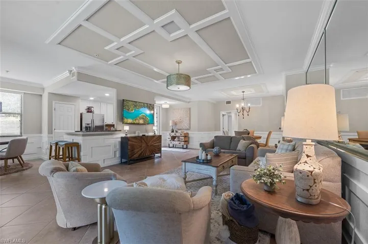 Tiled living room with a notable chandelier and coffered ceiling