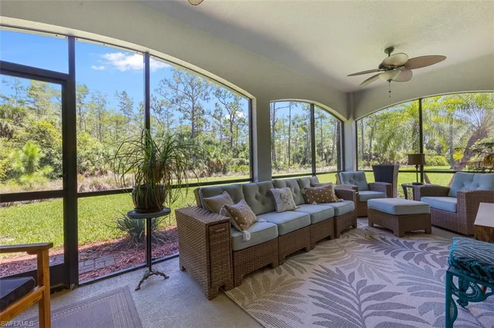 Sunroom / solarium with a wealth of natural light and ceiling fan