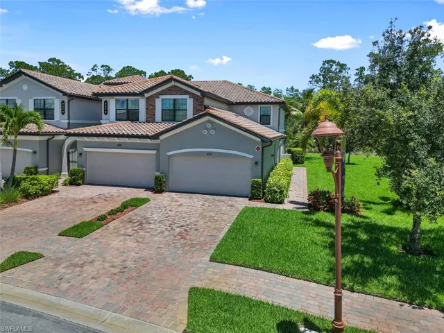 Mediterranean / spanish house featuring a front yard and a garage