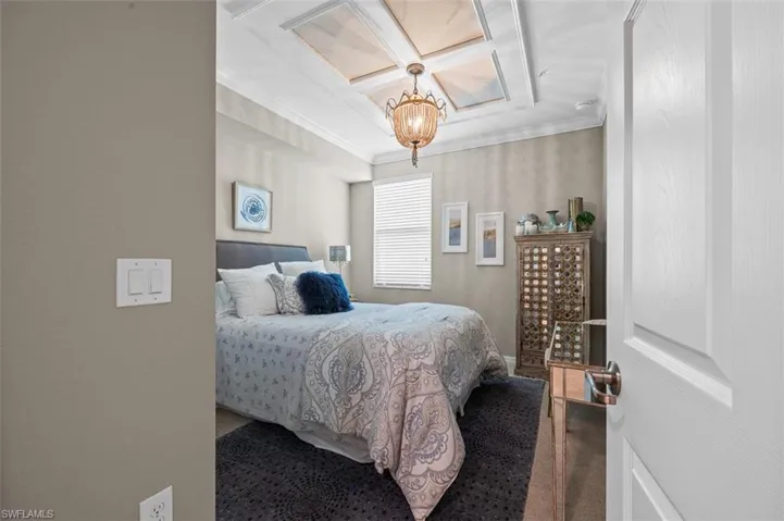 Bedroom featuring a chandelier and ornamental molding