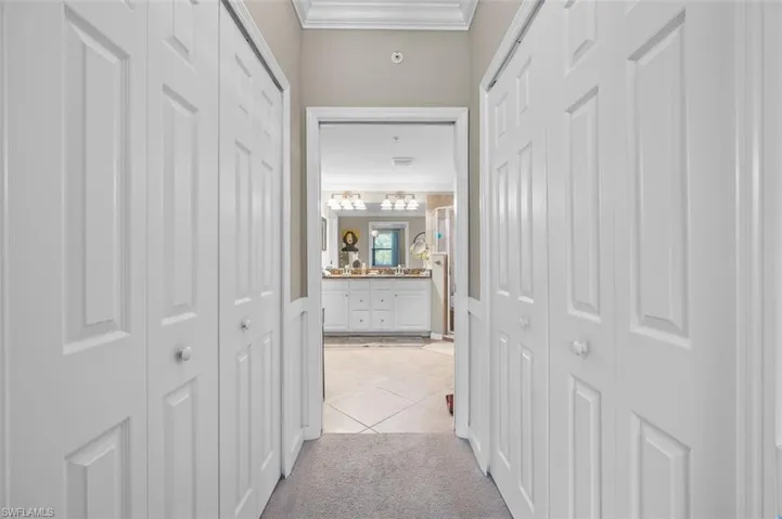 Hall featuring light carpet and ornamental molding