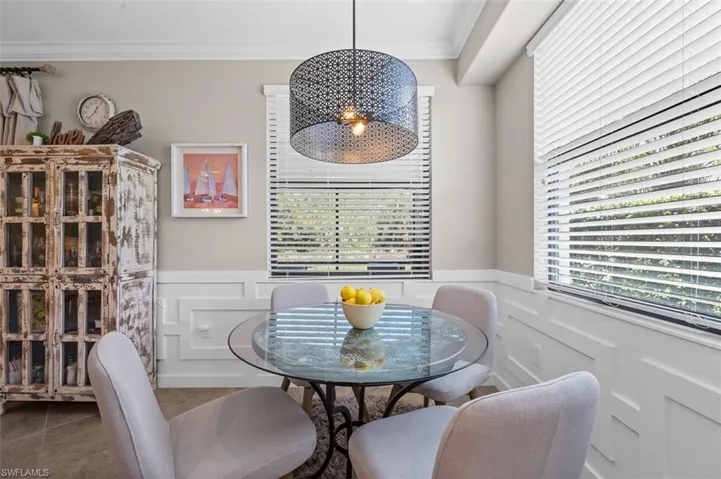 Dining room featuring tile flooring and ornamental molding