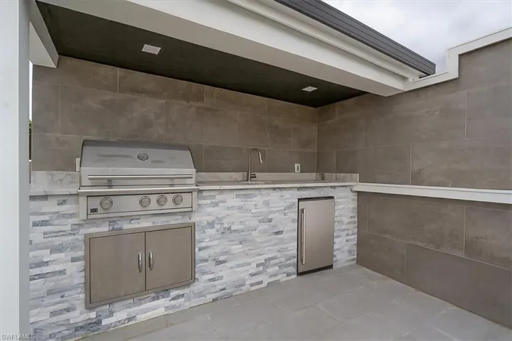 View of patio / terrace with grilling area and a sink