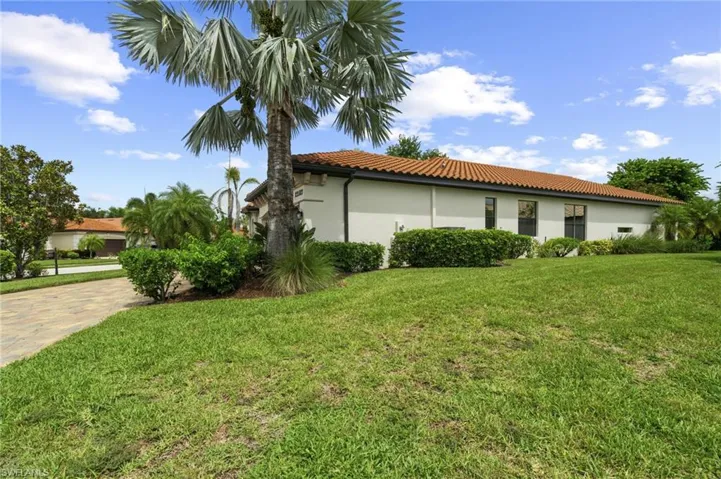 View of home's exterior with a lawn, stucco siding, and a tile roof