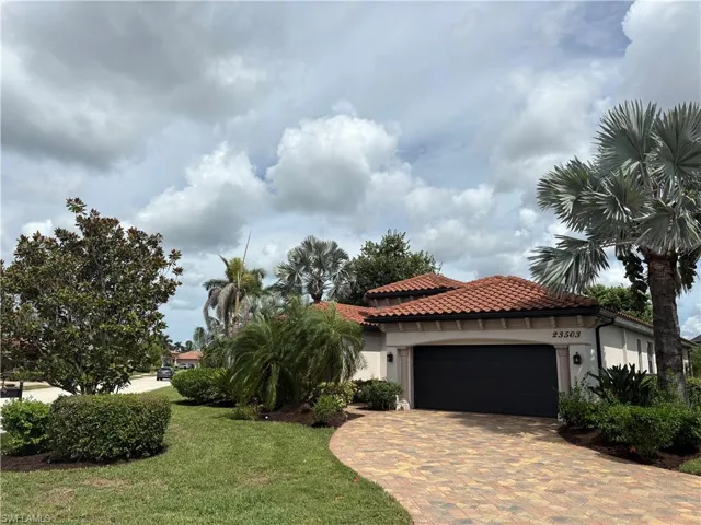 Mediterranean / spanish-style home with stucco siding, a garage, a tiled roof, decorative driveway, and a front yard